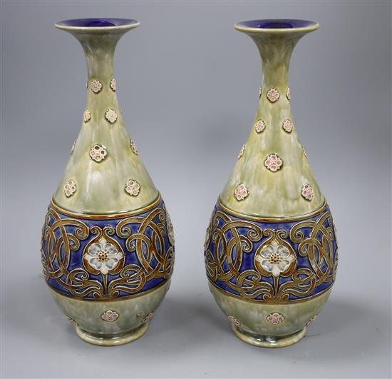 A pair of large Royal Doulton stoneware bottle vases, c.1905, with flower and Art Nouveau style whiplash design tendrils, height 34.5cm